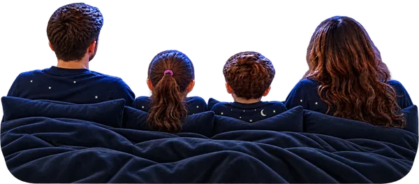 A family tucked up in bed, listening to a bedtime story